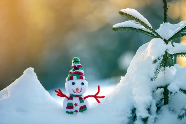 Small funny toy baby snowman in knitted hat and scarf in deep sn — Stock Photo, Image