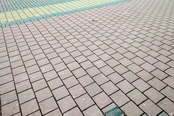 Stone pavement in perspective. Granite cobblestone pavement tile