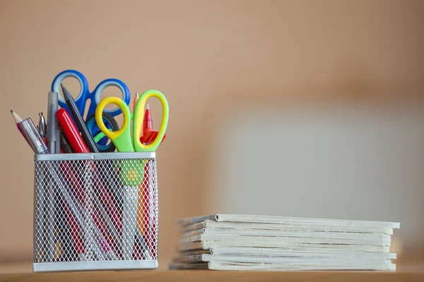 Stack of notebooks and stationery arrangement in classroom or office on copy space background — Stock Image Stack of notebooks and stationery arrangement in classroom or office on copy space background Royalty Free Stock Photos