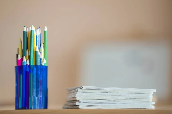 Wooden colorful drawing pencils arranged in plastic jug and stac — Stock Image Wooden colorful drawing pencils arranged in plastic jug and stac Stock Image