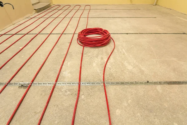 Heating red electrical cable wire roll on cement floor copy spac
