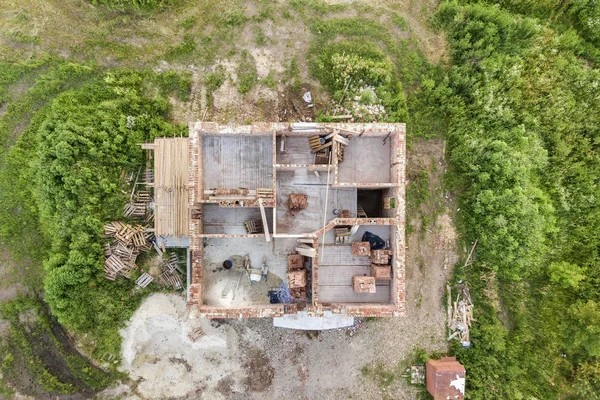 Aerial view of building site for future house, brick basement fl