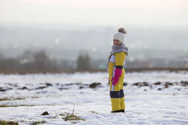Little child girl standing outdoors alone on snow covered winter — Stock Photo, Image