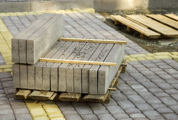 Installation of stone paving slabs in a yard.