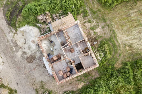 Aerial view of building site for future house, brick basement fl