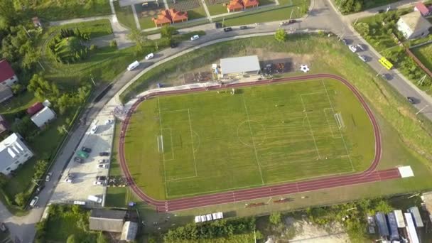 Aerial View Football Field Stadium Covered Green Grass Rural Town — Stock Video