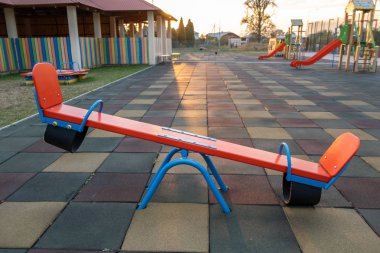 Rubber coating and flip flap swing at the playground at preschoo clipart