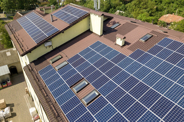 Aerial view of many solar panels mounted of industrial building 