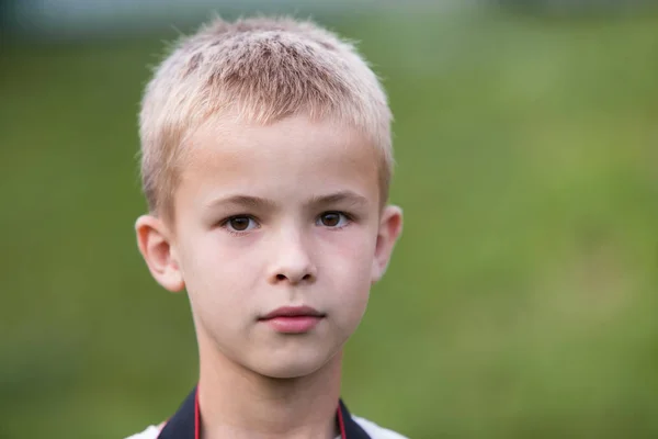 Portrait of a serious child boy outdoors. — ストック写真