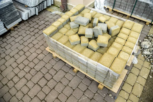 Installation of stone paving slabs in a yard.