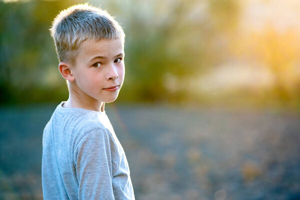 Portrait of a child boy outdoors on a warm sunny summer day.