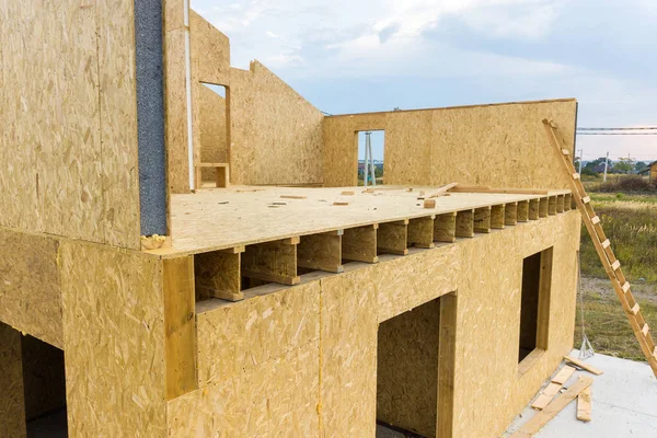 Stock image Construction of new and modern modular house. Walls made from composite wooden sip panels with styrofoam insulation inside. Building new frame of energy efficient home concept.