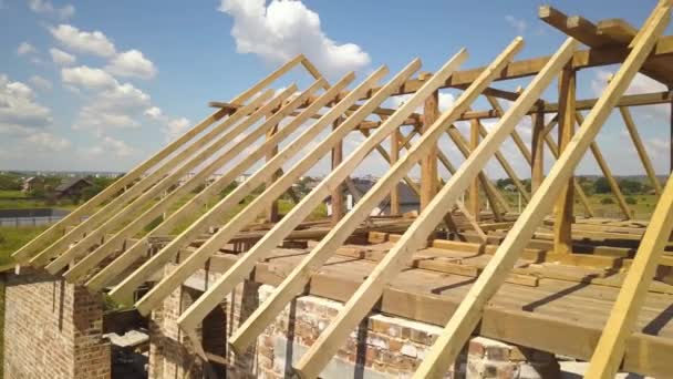 Aerial view of unfinished house with wooden roof frame structure under construction. — Stock Footage Aerial View Unfinished House Wooden Roof Frame Structure Construction Stock Video