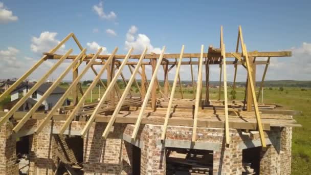 Aerial view of unfinished house with wooden roof frame structure under construction. — Stock Footage Aerial View Unfinished House Wooden Roof Frame Structure Construction Royalty Free Stock Footage
