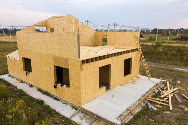 Yeni ve modern modüler evin inşaatı. İçinde köpük yalıtım malzemesi olan kompozit ahşap panellerden yapılmış duvarlar. Yeni enerji tasarruflu ev kavramı oluşturuluyor.