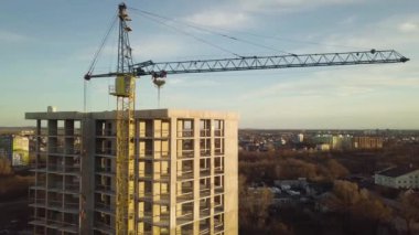 Bir şehirde inşaat halindeki tamamlanmamış uzun apartmanın beton çerçevesinin havadan görüntüsü..