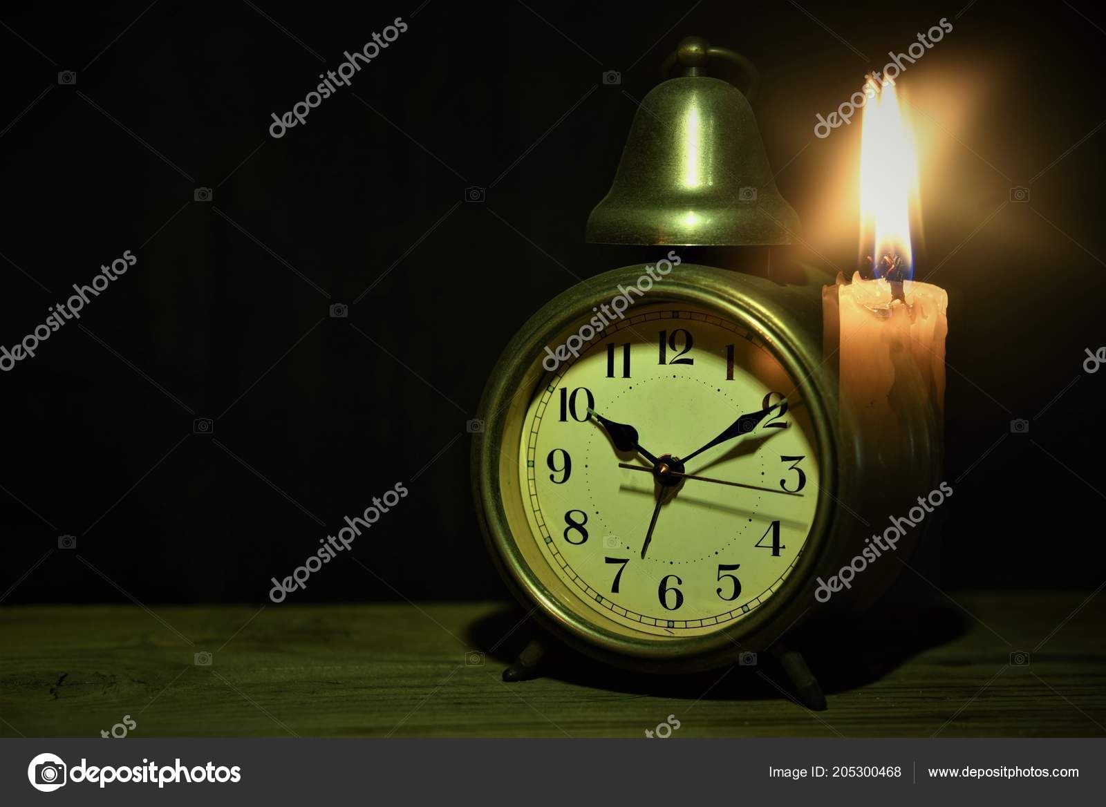 Alarm Clock Candle Iight Stock Photo by 205300468