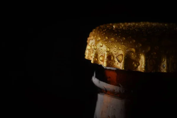 beer bottle cap closeup on dark background