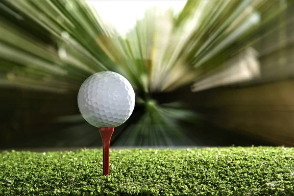 golf ball on red tee  on moving background