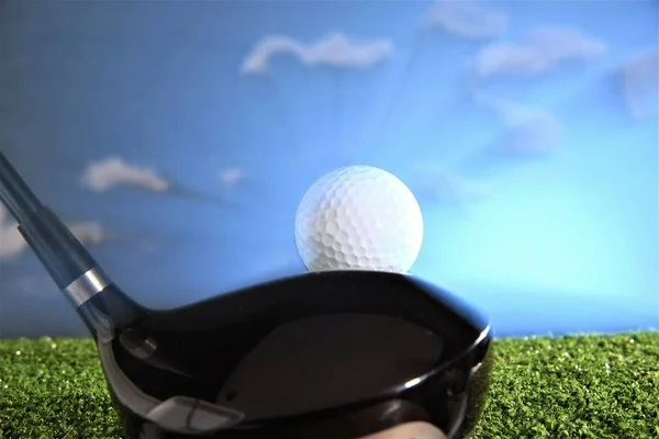 golf ball with driver club head on cloud sky background