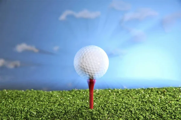 golf ball on red tee cloud sky background