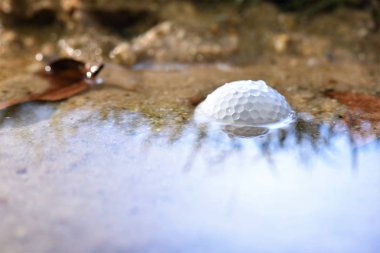 golf ball in water in sand banger clipart