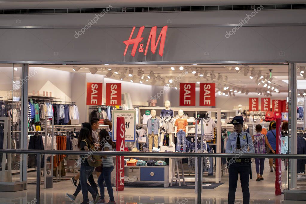 Manila, the Philippines - 22 March 2018: HM brand name on store entrance in SM Mall of Asia shopping mall. Fashion store sale. Casual wear shop. Famous retail company. Men and women clothes brand