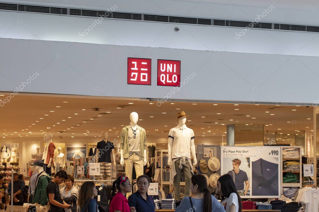 Manila, Philippines 22 March 2018: Uniqlo brand name on store entrance in SM Mall of Asia shopping mall. Modern fashion store label. Casual wear shop. Asian retail company. Men and women clothes brand