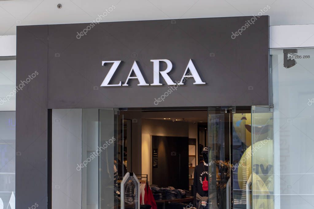 Manila, the Philippines - 22 March 2018: Zara brand name on store entrance in SM Mall of Asia shopping mall. Fashion store label. Casual wear shop. Famous retail company. Men and women clothes brand