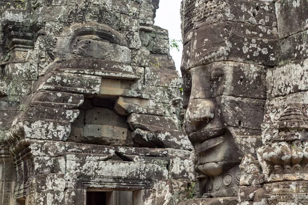 Mossy stone face of ancient buddhist temple Bayon in Angkor Wat complex, Cambodia. Ancient architecture of vanished civilization. Khmer art. Ancient temple stone face. Cambodian place of interest