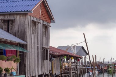 Kazık Kamboçya köyünde rustik müesseseden. Seyahat Koh Rong Adası. Pastoral manzara khmer balıkçılar ve deniz araçları. Tropik ada bir yaşam tarzı. Deniz suyu ayağı ayakta geleneksel ahşap ev