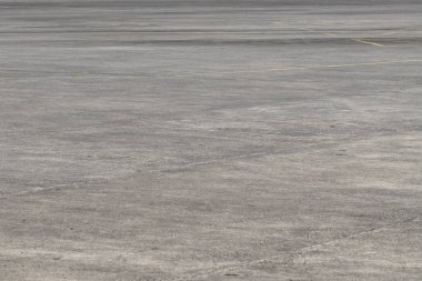 Empty asphalt airport space. Grunge asphalt perspective photo. Sunny faded grey asphalt background. Concrete place with yellow road marks. Airport field road. Modern airplane runway. Concrete surface clipart