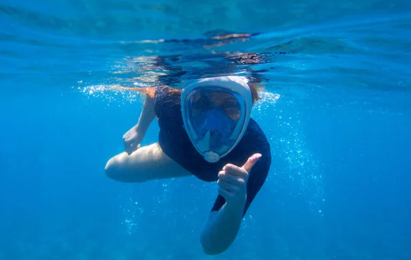 Woman snorkeling undersea portrait. Snorkel shows thumb up underwater. Happy woman snorkeling in blue water — Stock Photo, Image