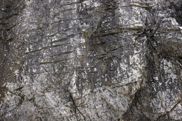 Fondo de textura de piedra agrietada. Superficie natural angustiada. Plantilla de diseño grueso. Roca volcánica agrietada superficie — Foto de Stock