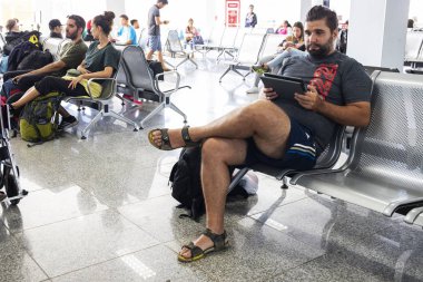 Puerto Princesa, the Philippines - 30 Nov 2018: people waiting for the flight in a local airport. Backpacker planning further trip