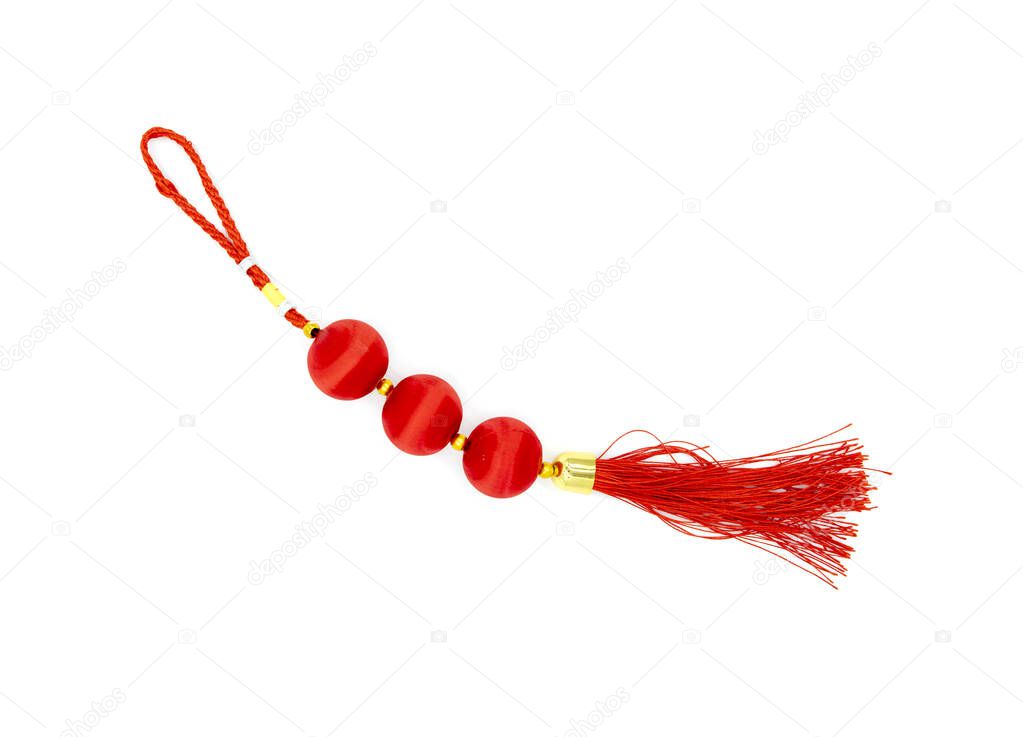 Festive red knot with tassel, top view photo. Asian holiday symbol. Red silk knot isolated. Chinese New Year decoration