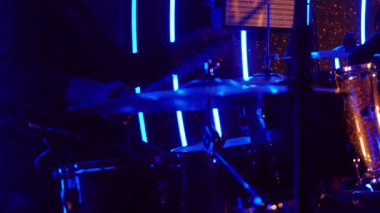 live music event featuring a drummer performing passionately on stage, representing rhythm and entertainment culture.