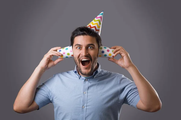 Handsome Cheerful Young Brunet Guy Party Cap Covering Ears Paper — Stock Photo, Image