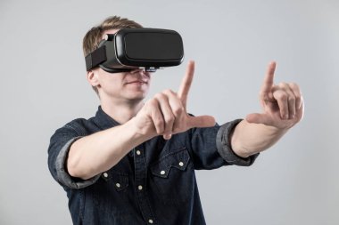 İnsan sanal gerçeklik gözlükleri kullanmak ve gri arka plan üzerinde çerçeve