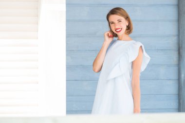 Güzel mavi ahşap arka plan karşı Genç Sevimli gülümseyen kız portresi