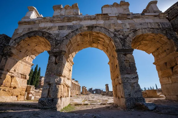 Antique ruins, city gate - Hierapolis, Pamukkale, Turkey. Wide angle.