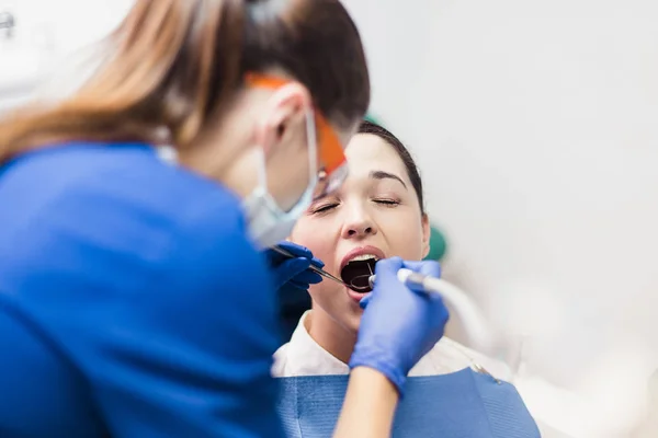 Dentist holding tooth whitening procedure