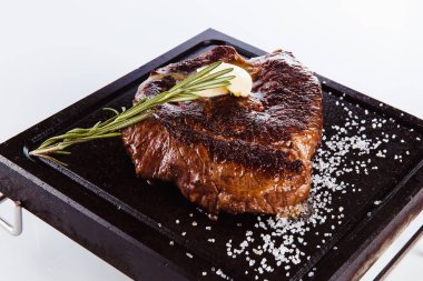 Beyaz bir arka planda (yakın bir sıcak granit plaka üzerinde ızgara et biftek)