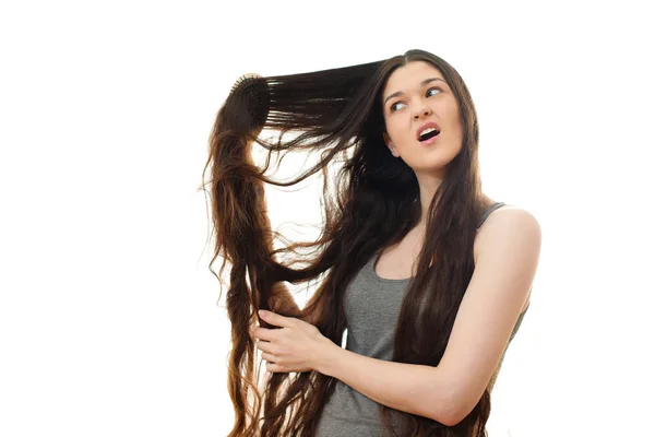 Young woman with problem hair. White background — Stock Photo, Image