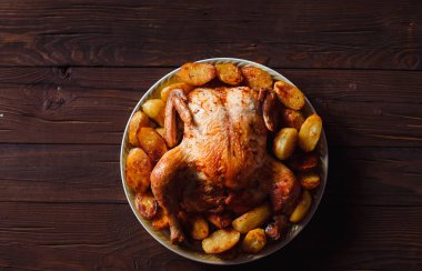 koyu ahşap arka plan üzerinde altın kabuk ile kızarmış tavuk (üst görünümü yakın)