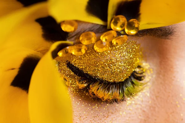 Beauty portrait of a brunette with extended eyelashes in the image of a tulip.    .