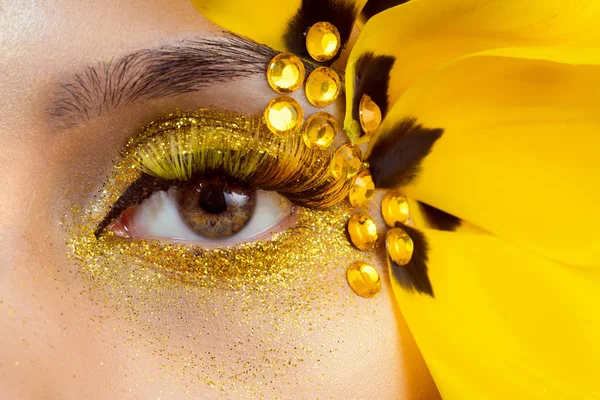 Beauty portrait of a brunette with extended eyelashes in the image of a tulip.    .