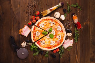 ahşap koyu arka plan (yakın üst görünümü) üzerinde jambon ve mantar ile İtalyan pizza. Tek parça kes