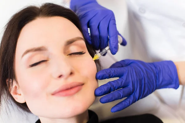 Arts cosmetologist injecteert het gezicht van de patiënt — Stockfoto