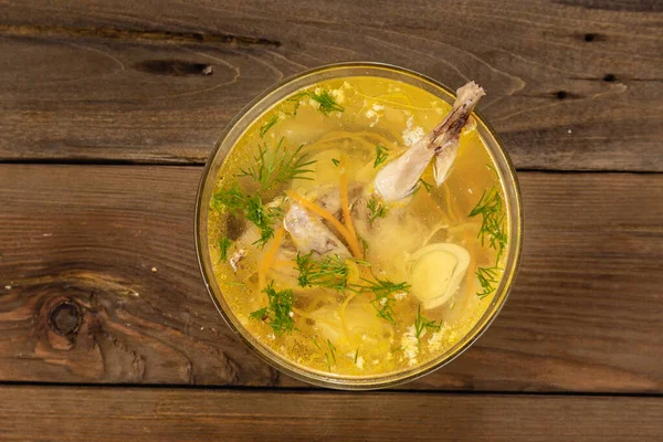 Bouillon quail egg in a transparent round plate on a wooden background — Stock Image Bouillon Quail Egg Transparent Plate Wooden Background Stock Image